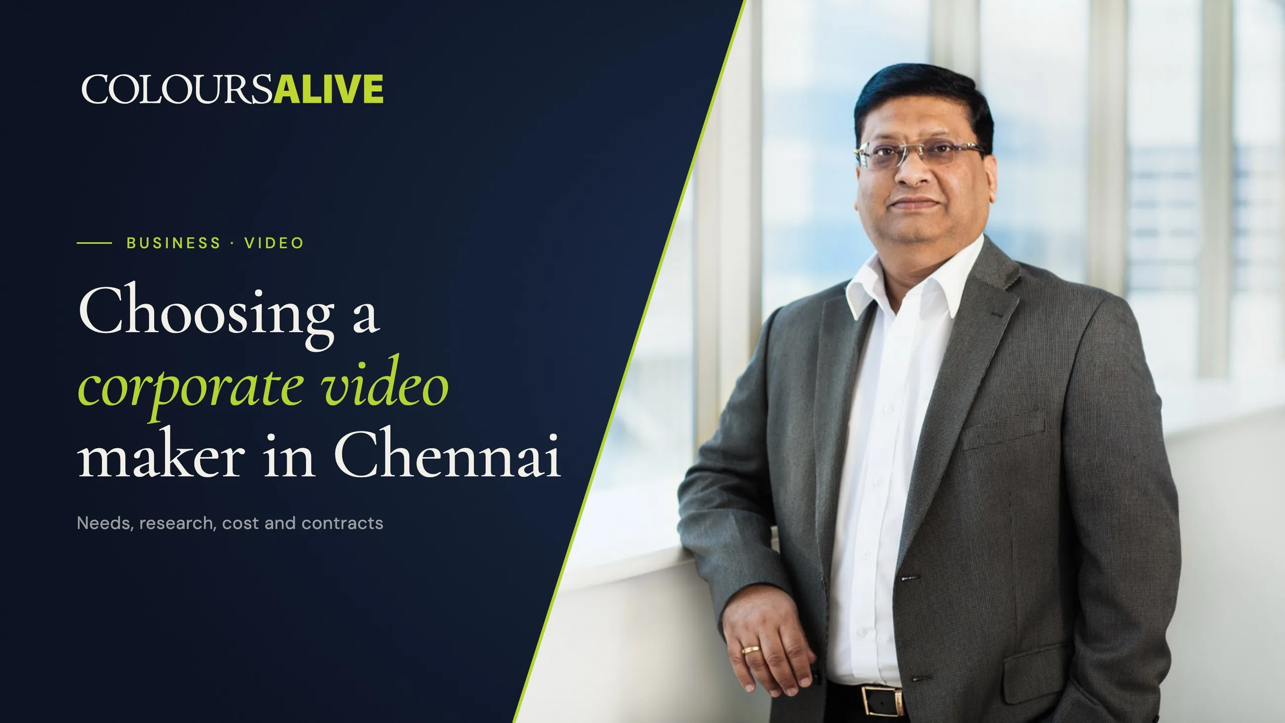 Choosing a corporate video maker in Chennai, beside a standing portrait of a Nokia Chennai executive by a full-height office window