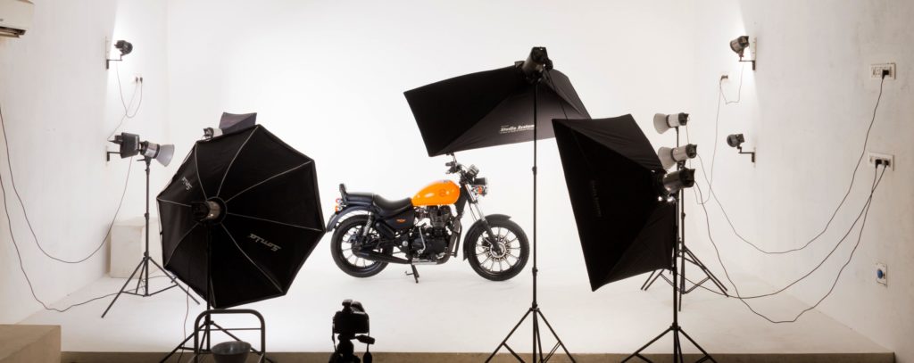 Royal Enfield customised by The Bullet Factory photographed on a white background with studio flashes in the foreground